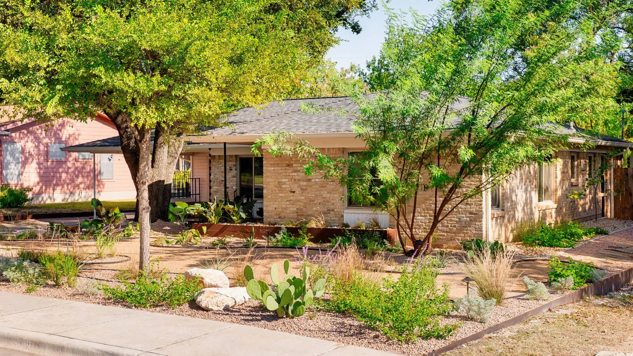Front entrance landscape featuring layered plantings and steel landscape borders — Southern Love
