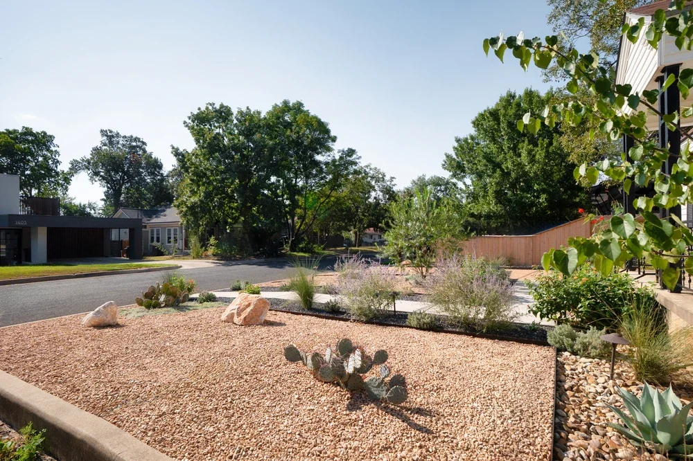 Drought-tolerant front yard landscaping with gravel, native plants, and cacti, perfect for winter-ready low-water maintenance.