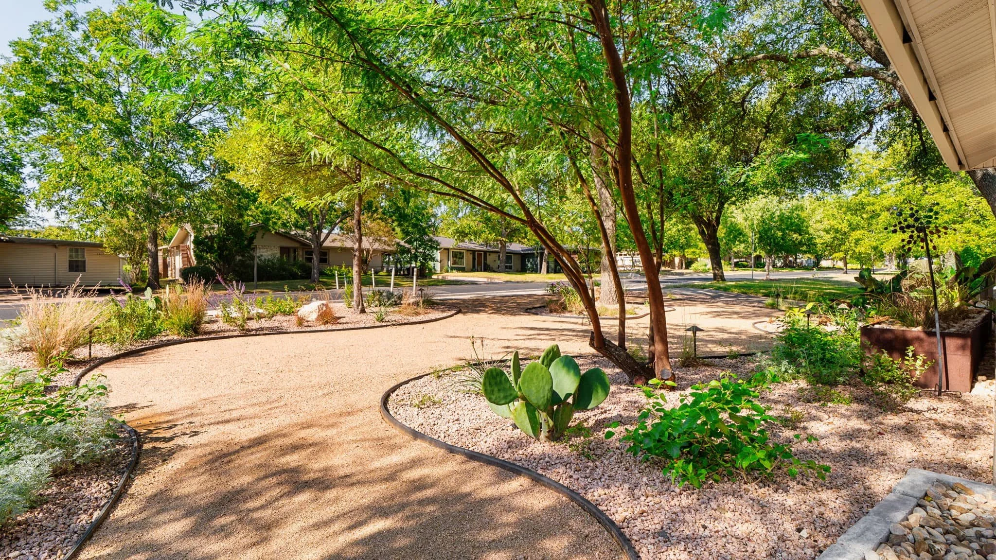 Residential landscape renovation with wood fencing and clean gravel groundcover — Southern Love