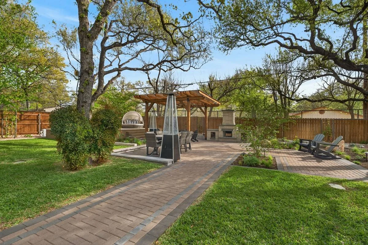 Herringbone paver walkway through the lawn to the dining pergola and fireplace — Southern Love Landscaping & Design