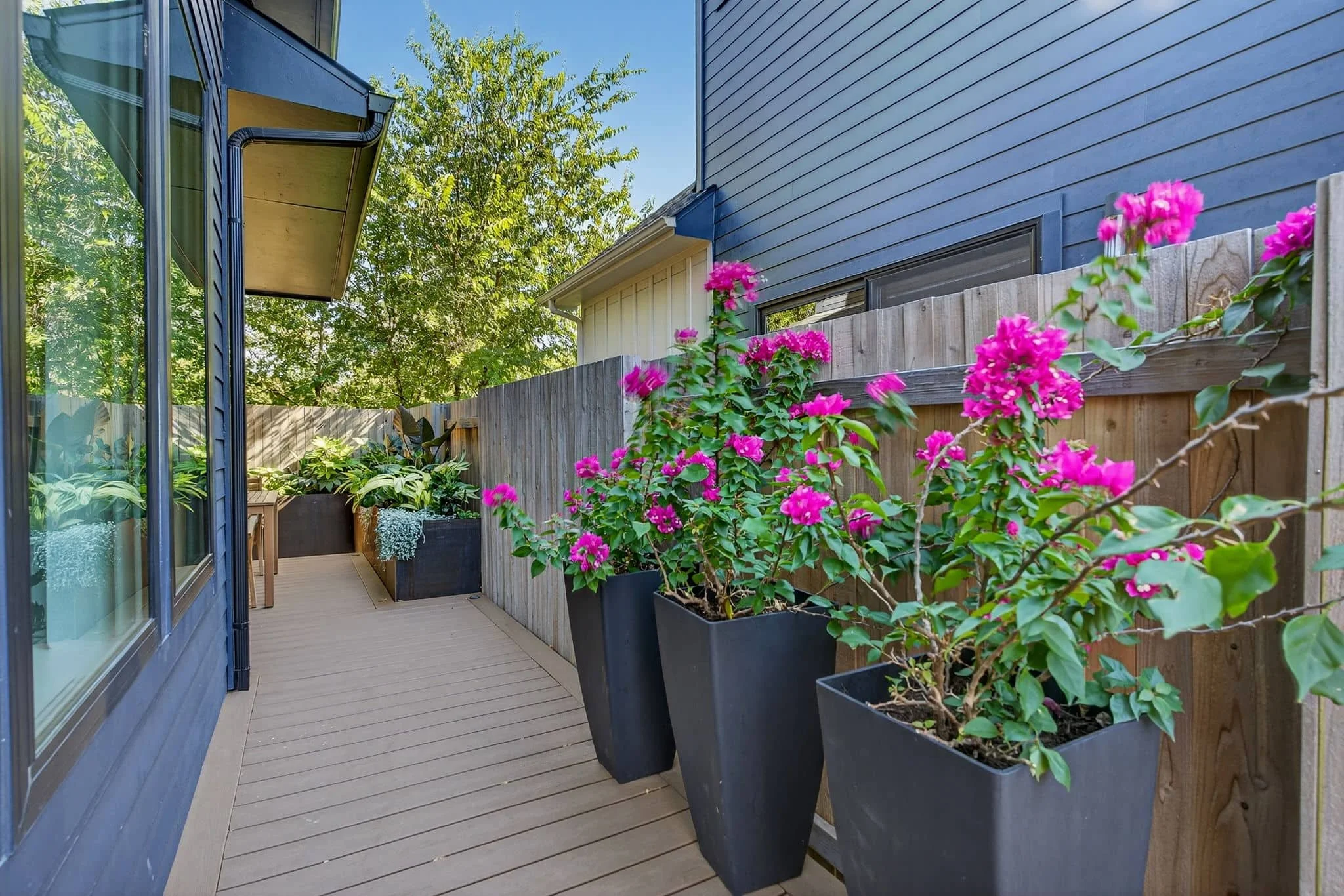 Residential landscape renovation with warm decking and clean gravel groundcover — Southern Love