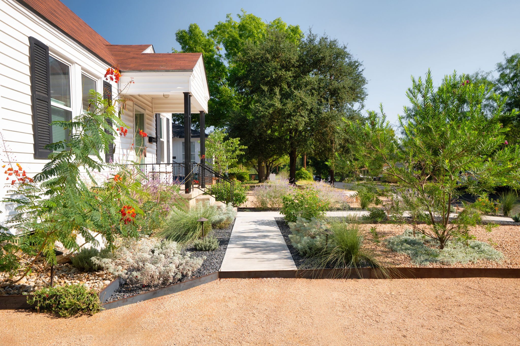Front entryway cement walkway and seasonal plantings