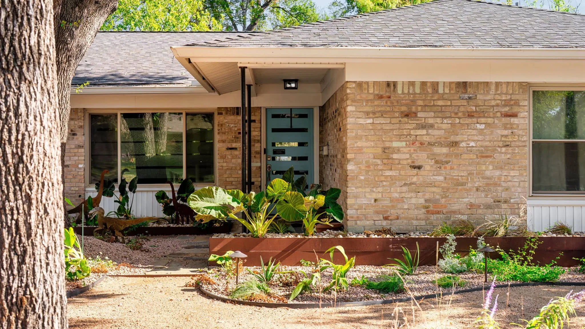 Front entry landscape featuring wood fencing and modern planting design — Southern Love