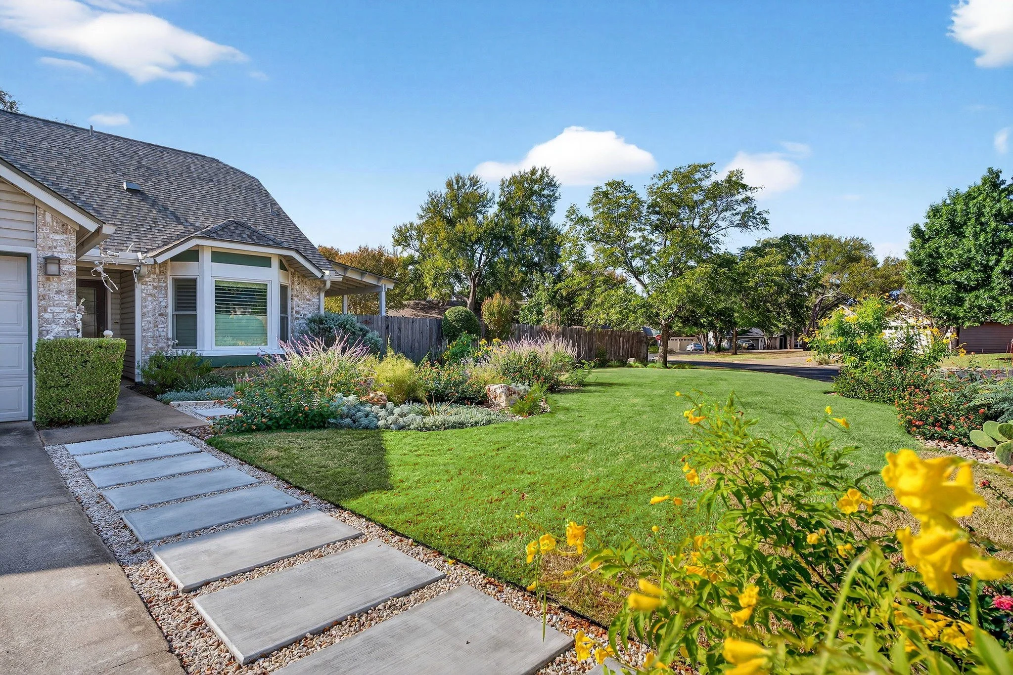 Front lawn with paver walkway and plantings in Austin, TX