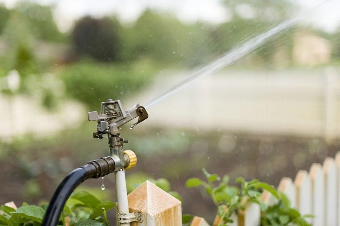 A sprinkler system watering a yard.