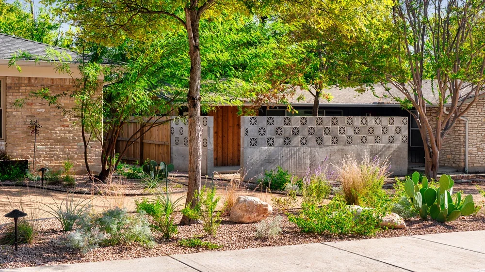 Low water landscaping with native plants and stone accents suited for rocky Hill Country conditions in Austin.