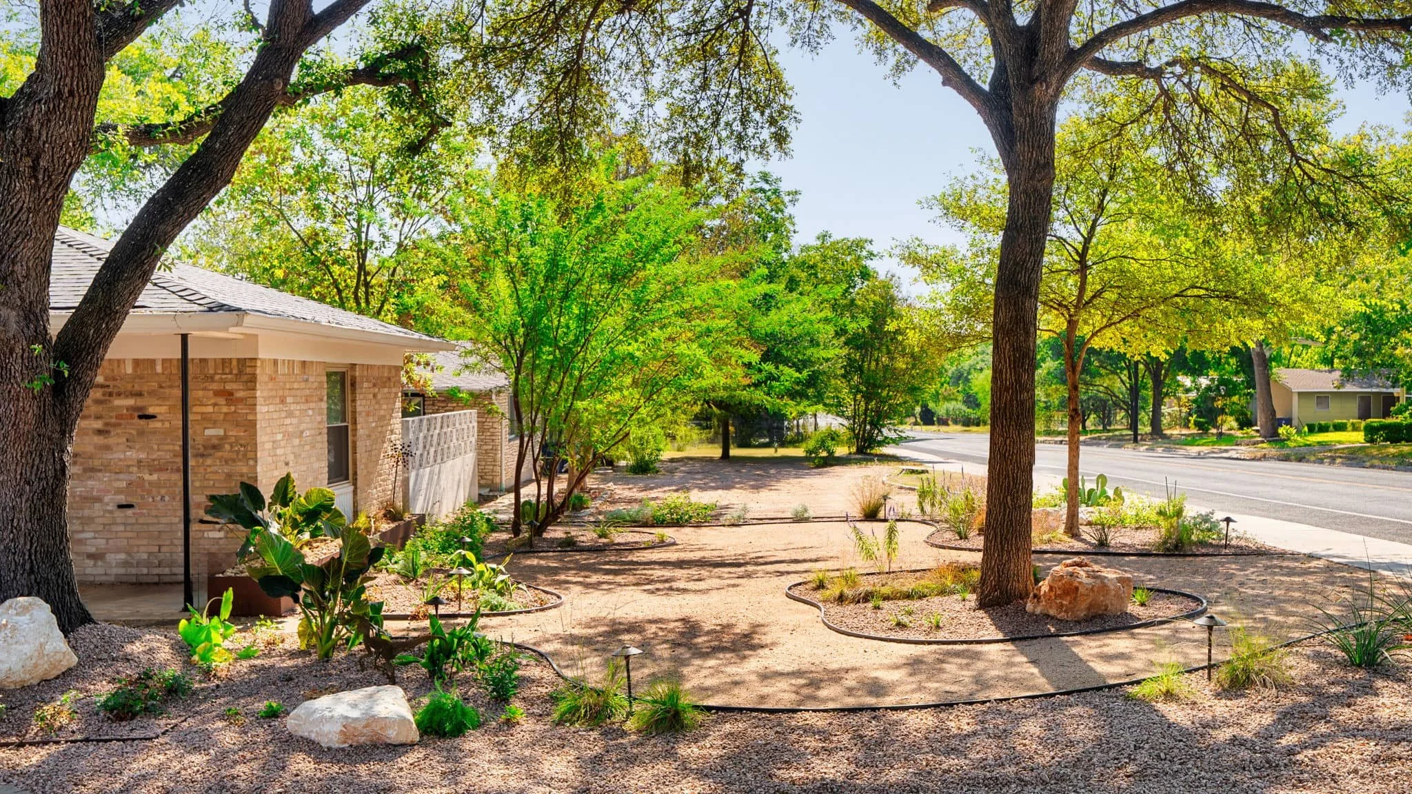 Brick home landscaping with low-maintenance planting and modern edging details — Southern Love