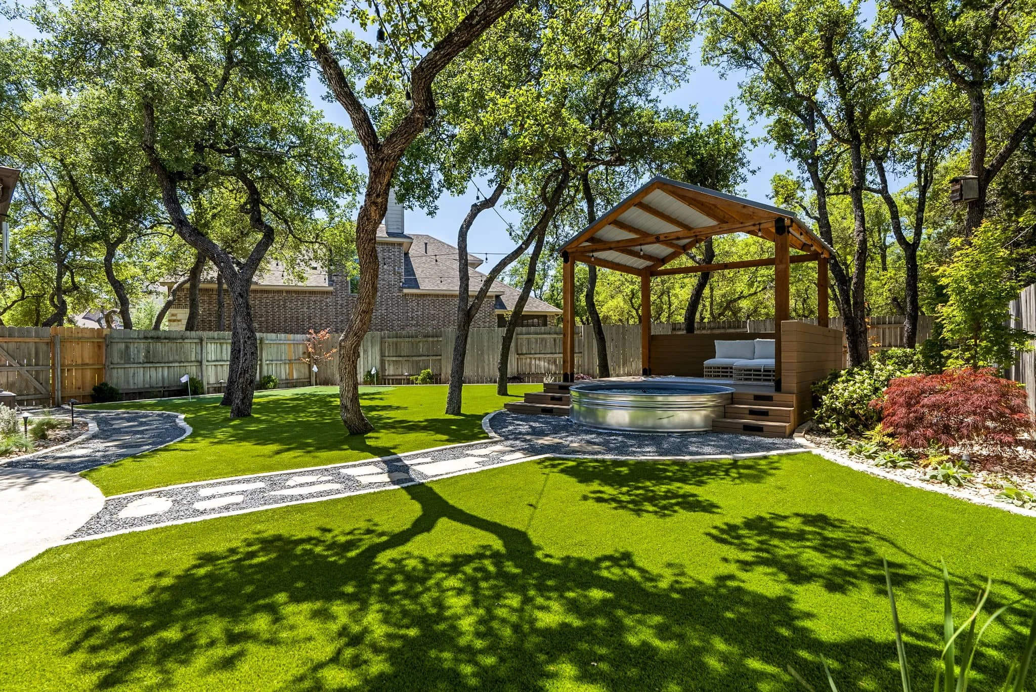 Backyard retreat with shaded outdoor living area and organized landscape layout — Southern Love