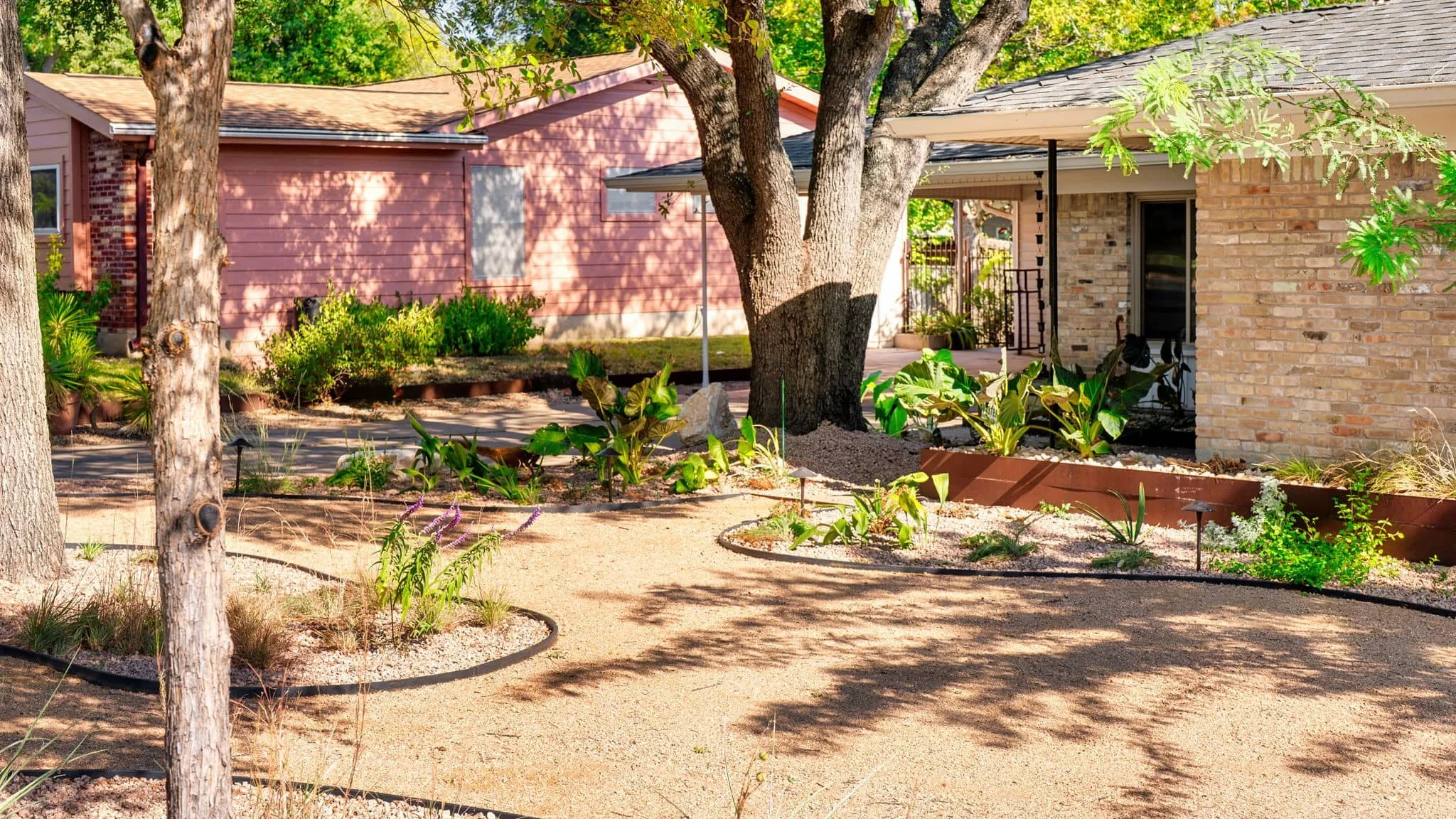 Front landscape installation with steel edging and natural-style planting beds — Southern Love