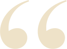 An image of gold quotation marks on a black background.