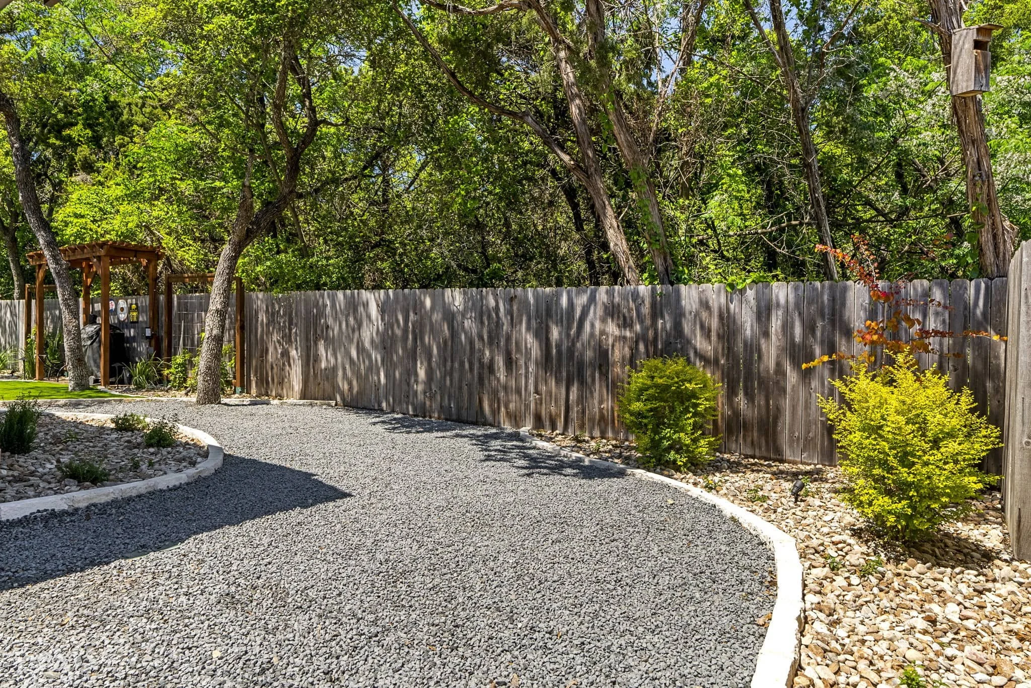 Luxury outdoor living space with low-maintenance landscaping and artificial turf — Southern Love