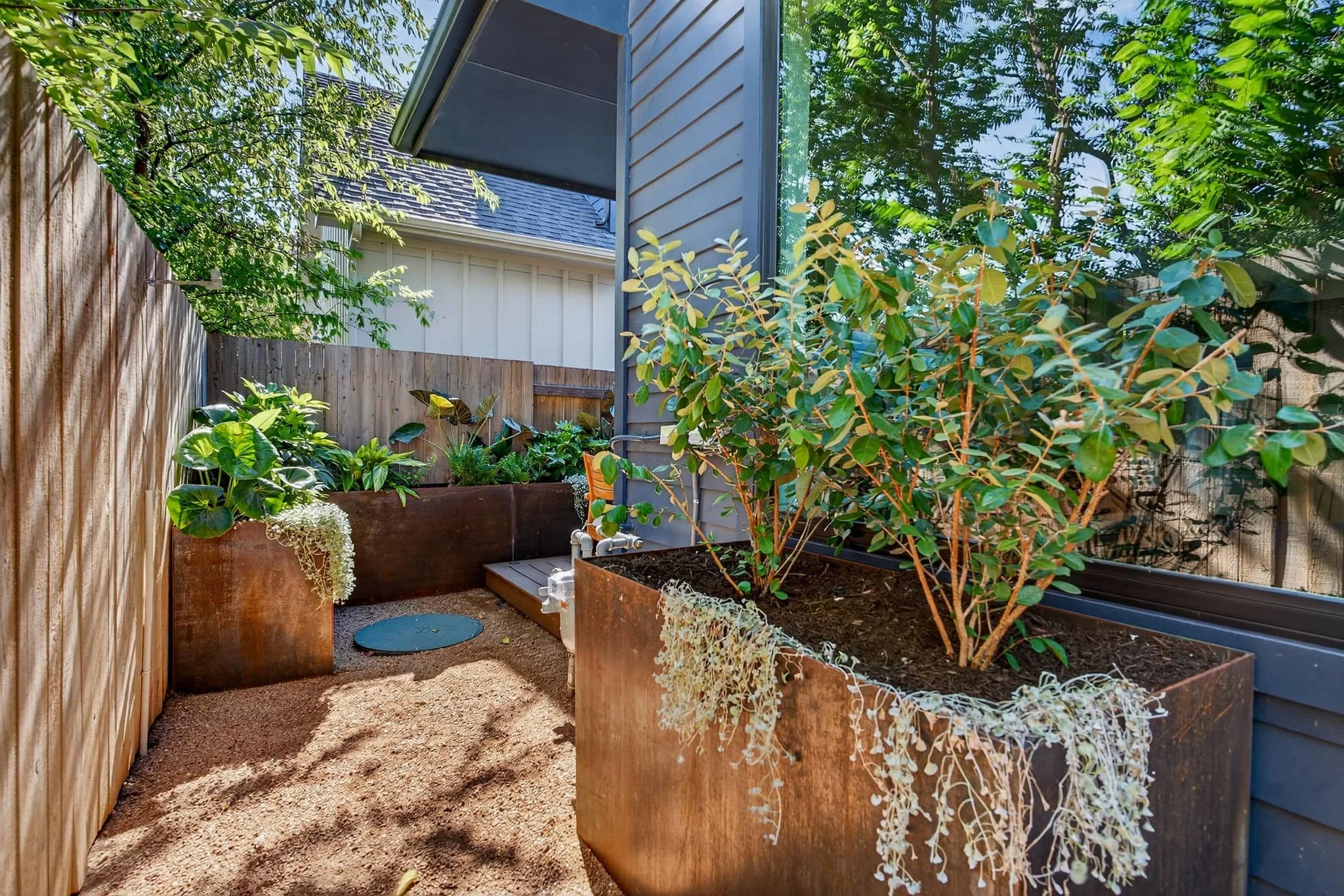 Modern side-yard retreat with raised planters and low-maintenance landscape layout — Southern Love