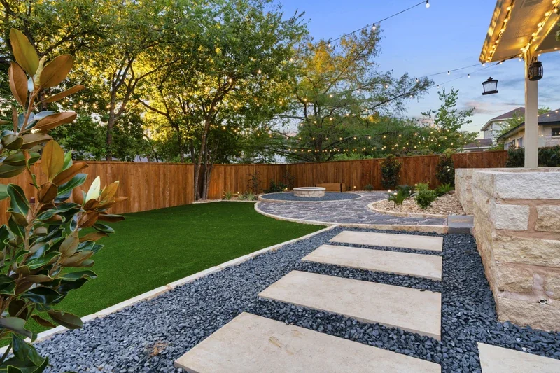 Backyard hardscaping with stone paths, lighting, and a fire pit, ideal for winter patio enjoyment and January upgrades.