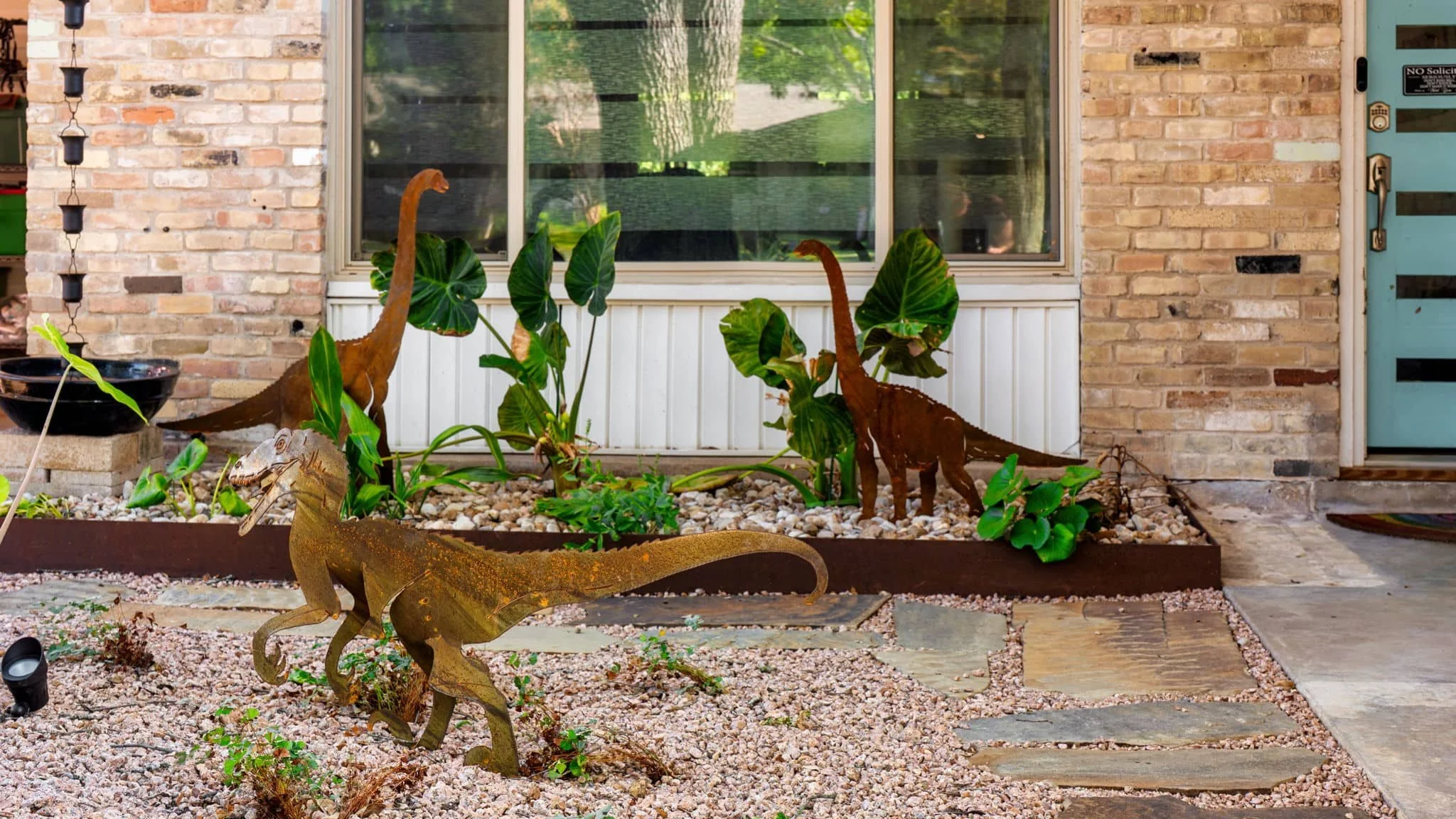 Contemporary front yard landscaping with layered greenery and steel landscape edging — Southern Love