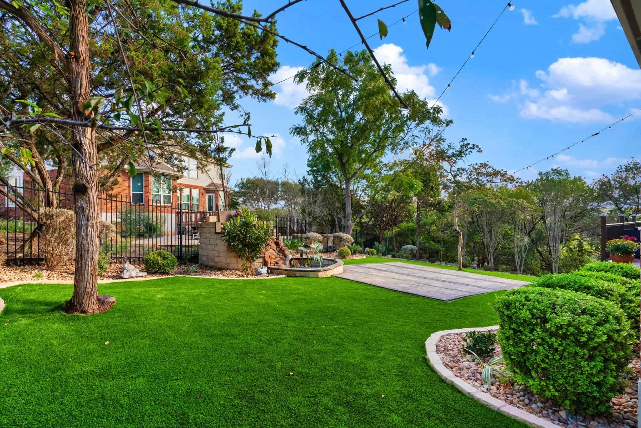 A gorgeous yard with a professionally installed landscape and a sturdy paver patio.