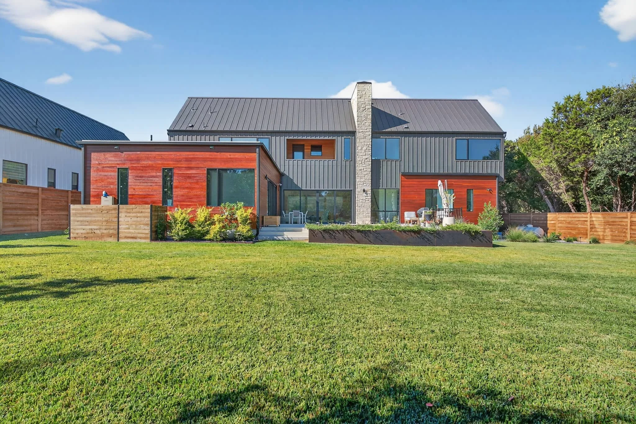 Modern backyard retreat featuring structured lawn space and outdoor lounge seating — Southern Love