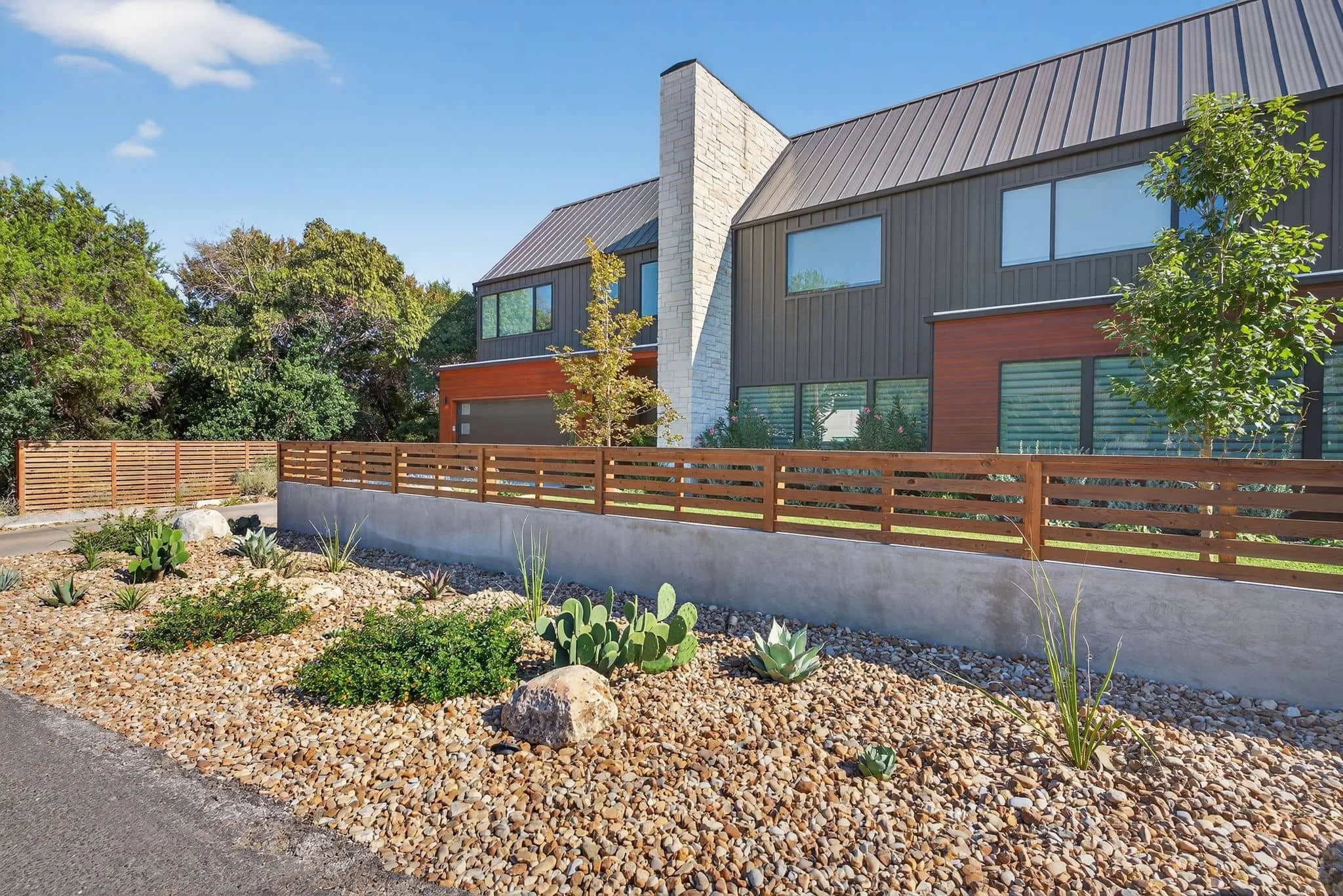Contemporary front entrance landscaping with minimalist planting and gravel accents — Southern Love