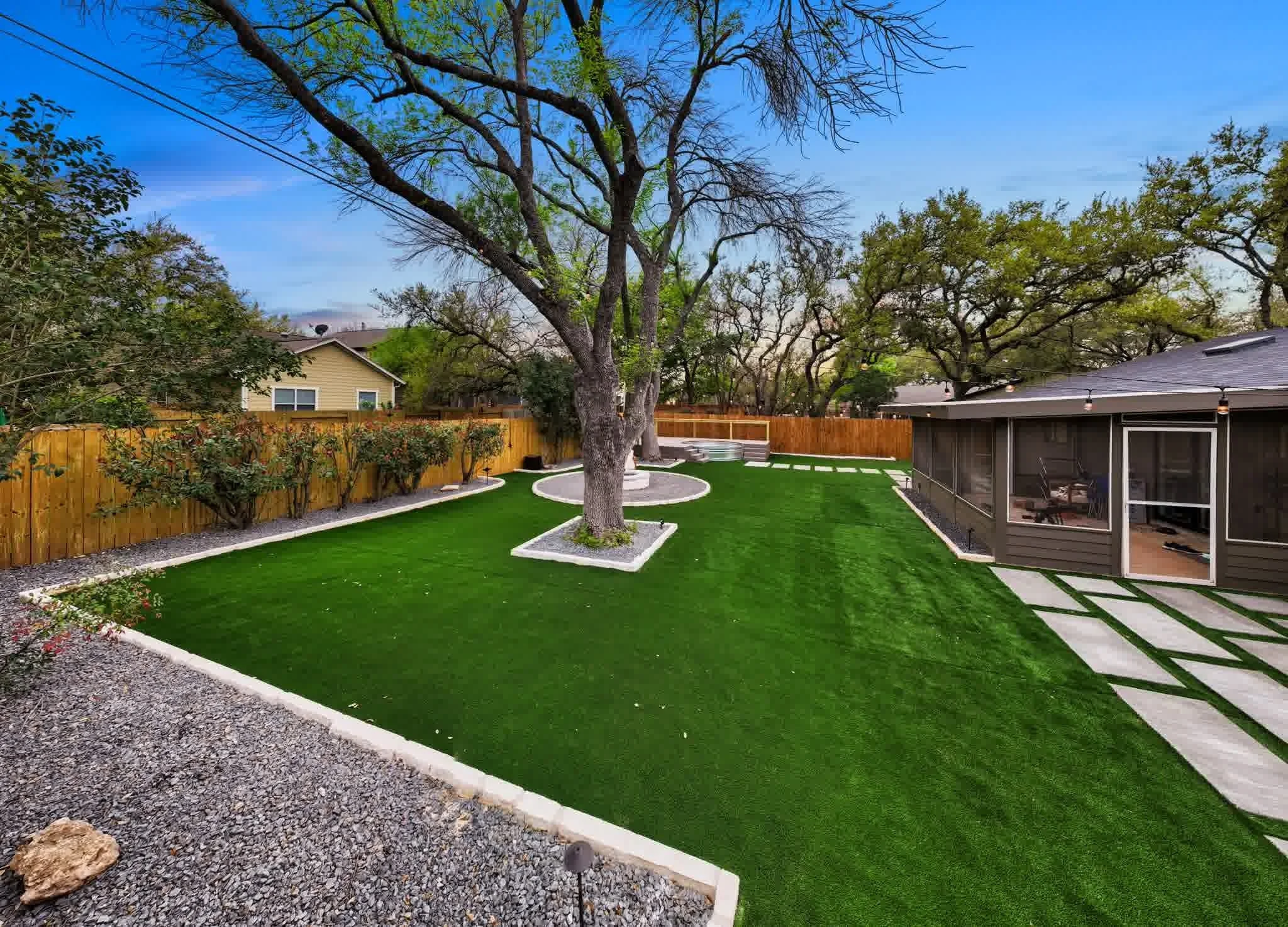 A spotless yard with artificial turf rather than grass.
