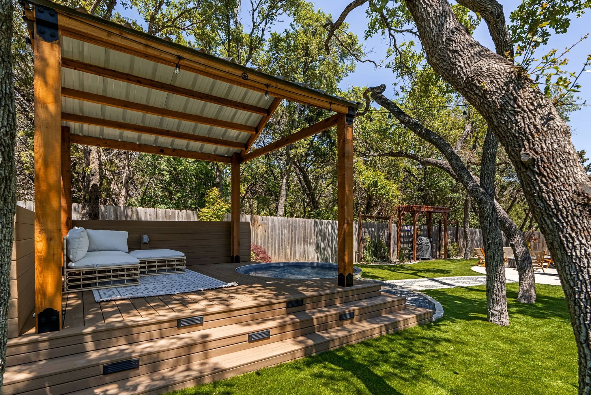 Backyard landscape design featuring defined walkways and modern outdoor lounge space — Southern Love