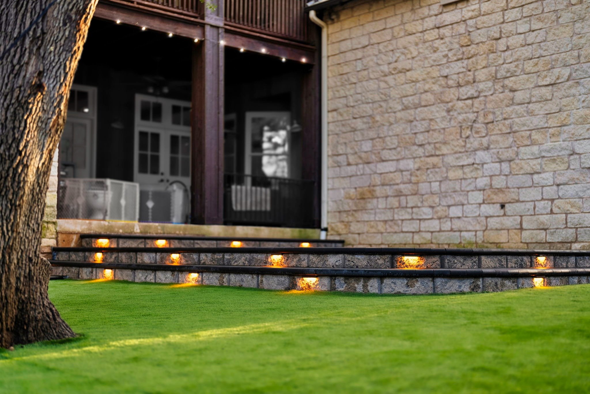 A happy client’s backyard with a fresh patio and amazing artificial turf.