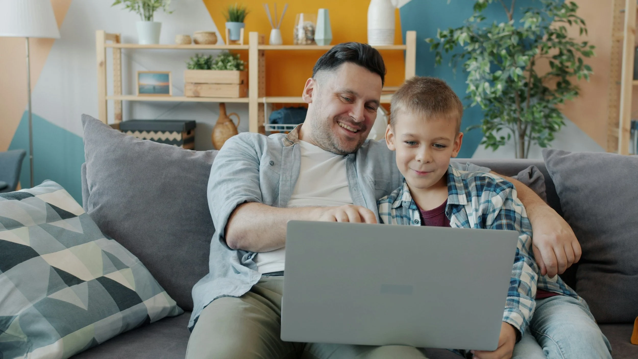 photo of dad and son looking at a computer together