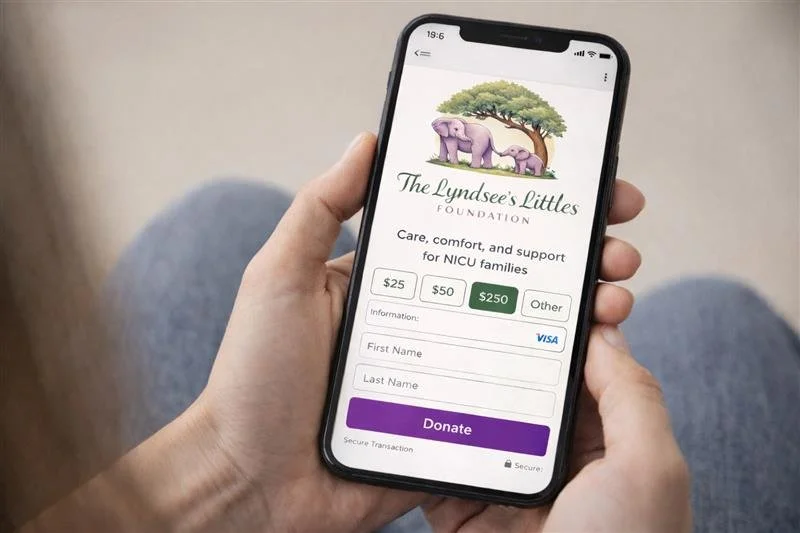 Someone holding a smartphone displaying a donation page for The Lyndae's Littles Foundation, with options to donate $25, $50, or $250, and fields for personal information and credit card details.