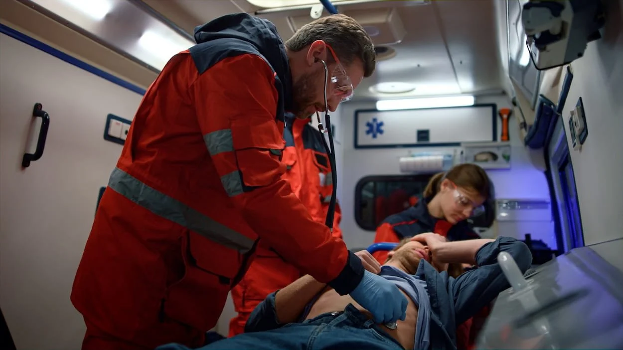 Paramedics providing emergency care to a patient during a severe allergic reaction inside an ambulance.