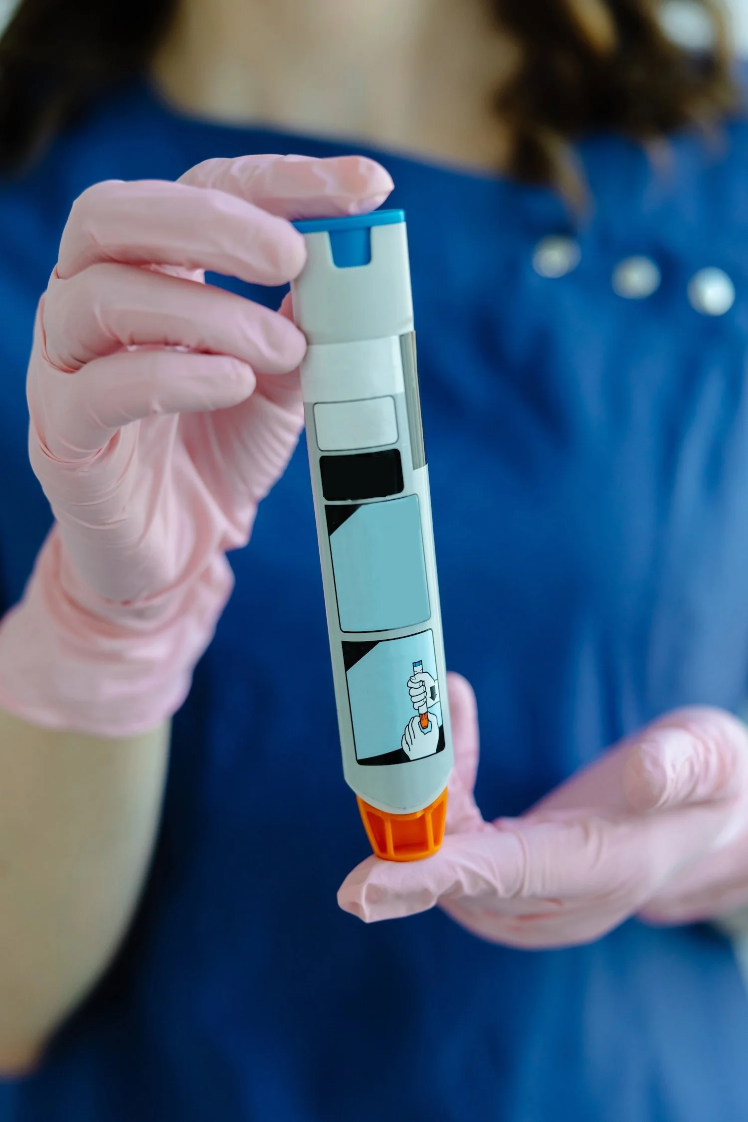 Person wearing pink gloves holding a rapid test kit for COVID-19.
