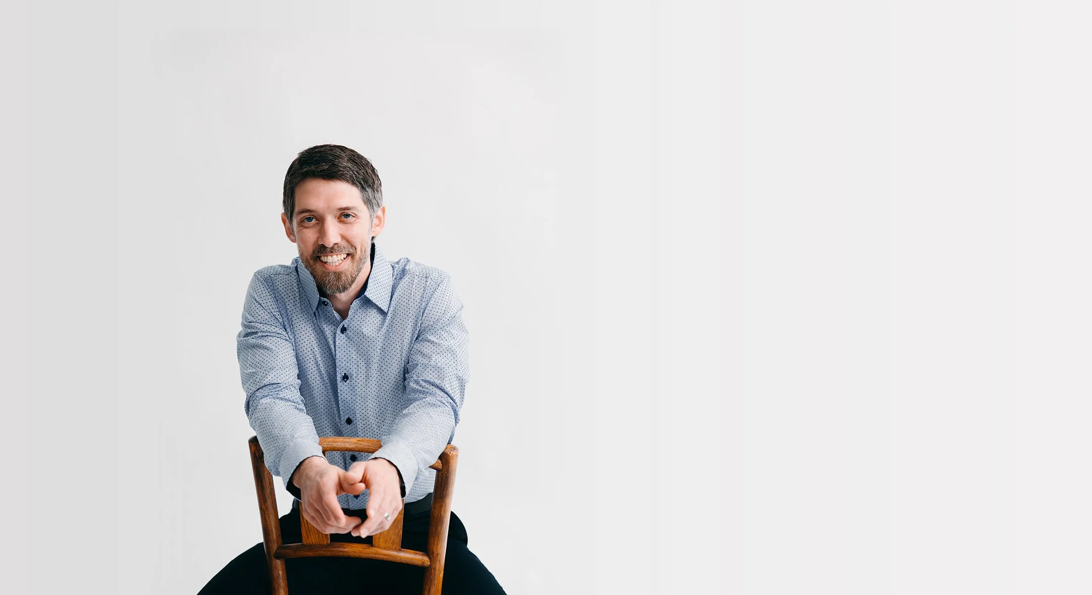 conrad bear leaning on wooden chair