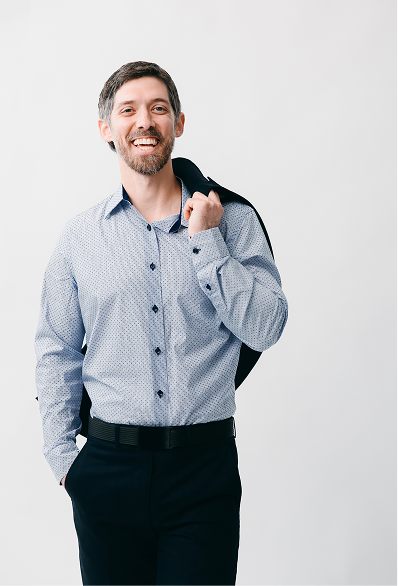 conrad bear smiling with a coat hanging over his shoulder