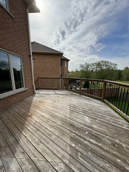 Wood washing and refinishing service removing years of buildup from deck surface