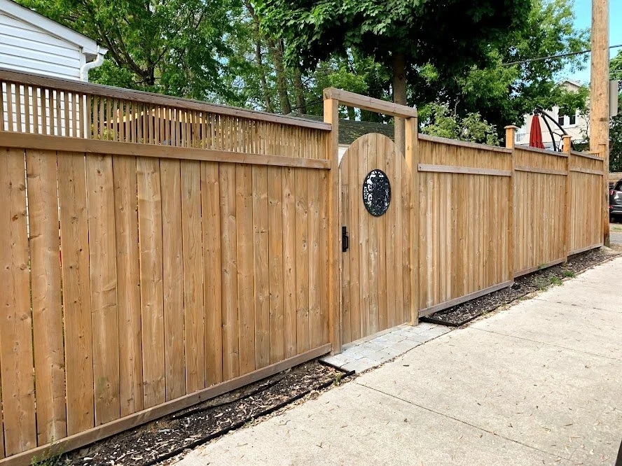 Wood fence restoration using professional washing and staining techniques