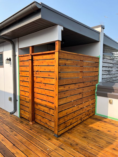 Pressure treated privacy wall refinishing in Toronto including repairs and full stain application
