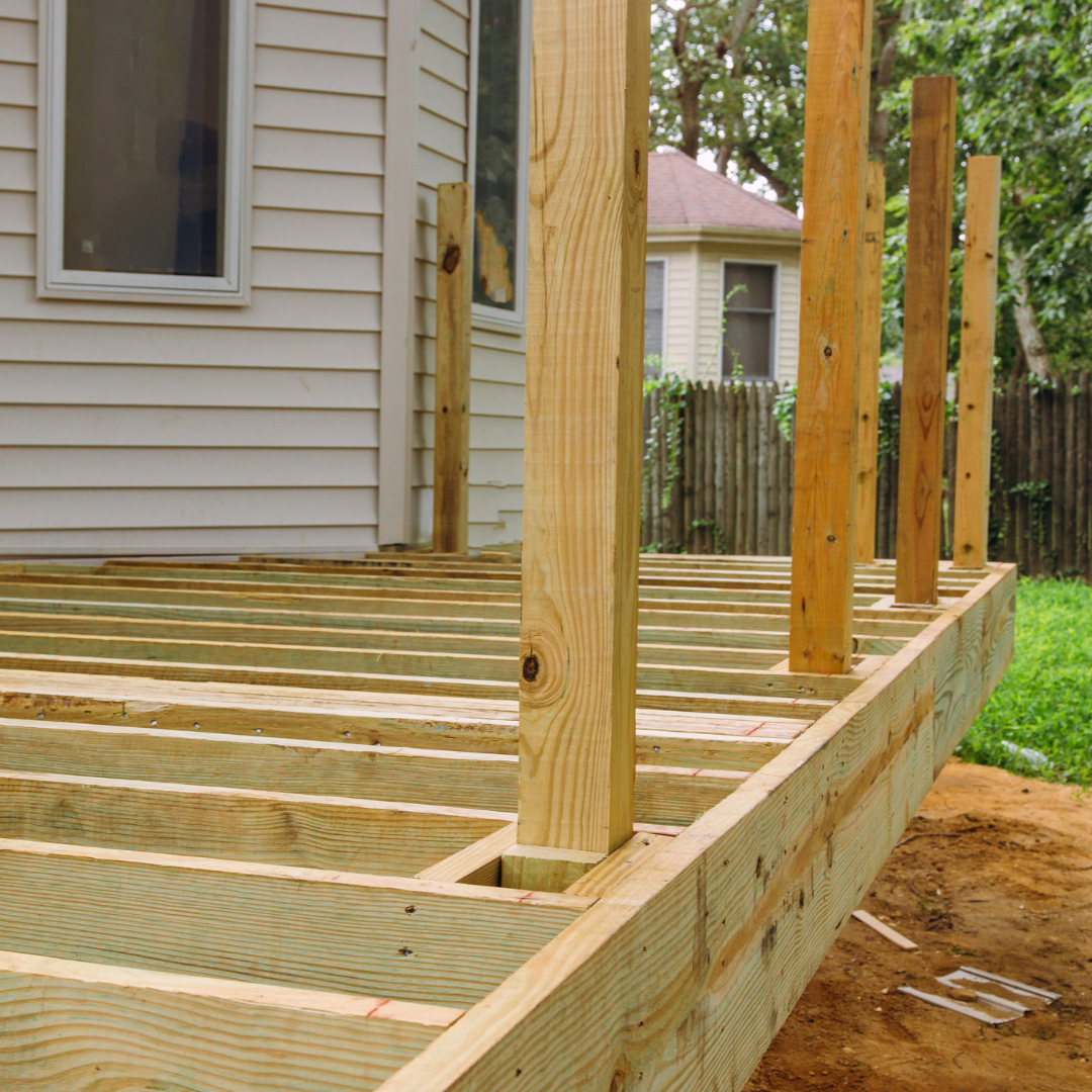 Professional deck staining service enhancing natural wood grain on residential property