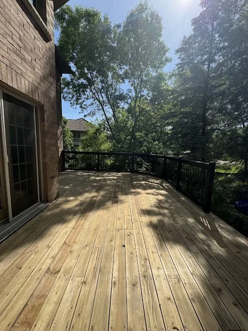Pressure treated backyard deck refinishing in Toronto featuring new board installation, washing, sanding and staining using oil based stain and sealer
