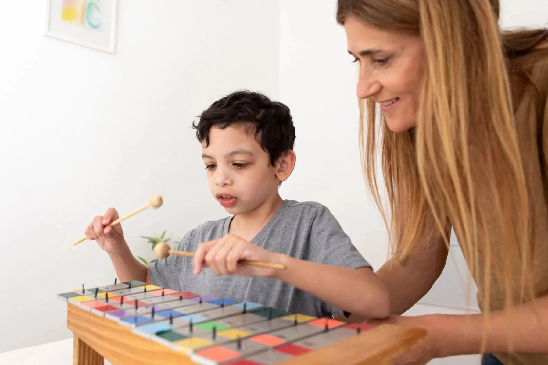 Child using a musical instrument during a guided sensory activity