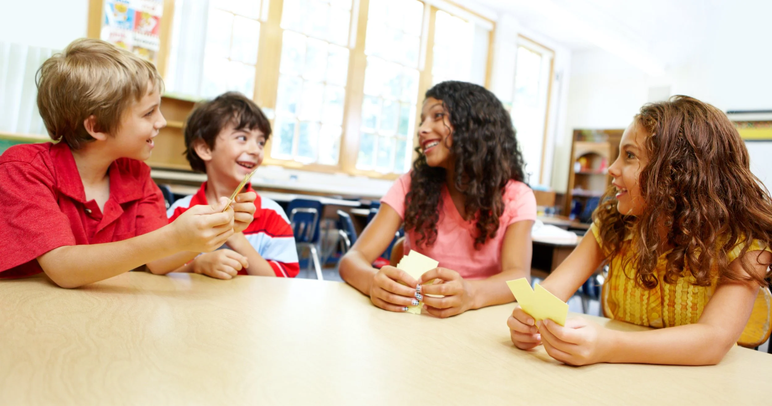 students seated together at a classroom table during a collaborative activity