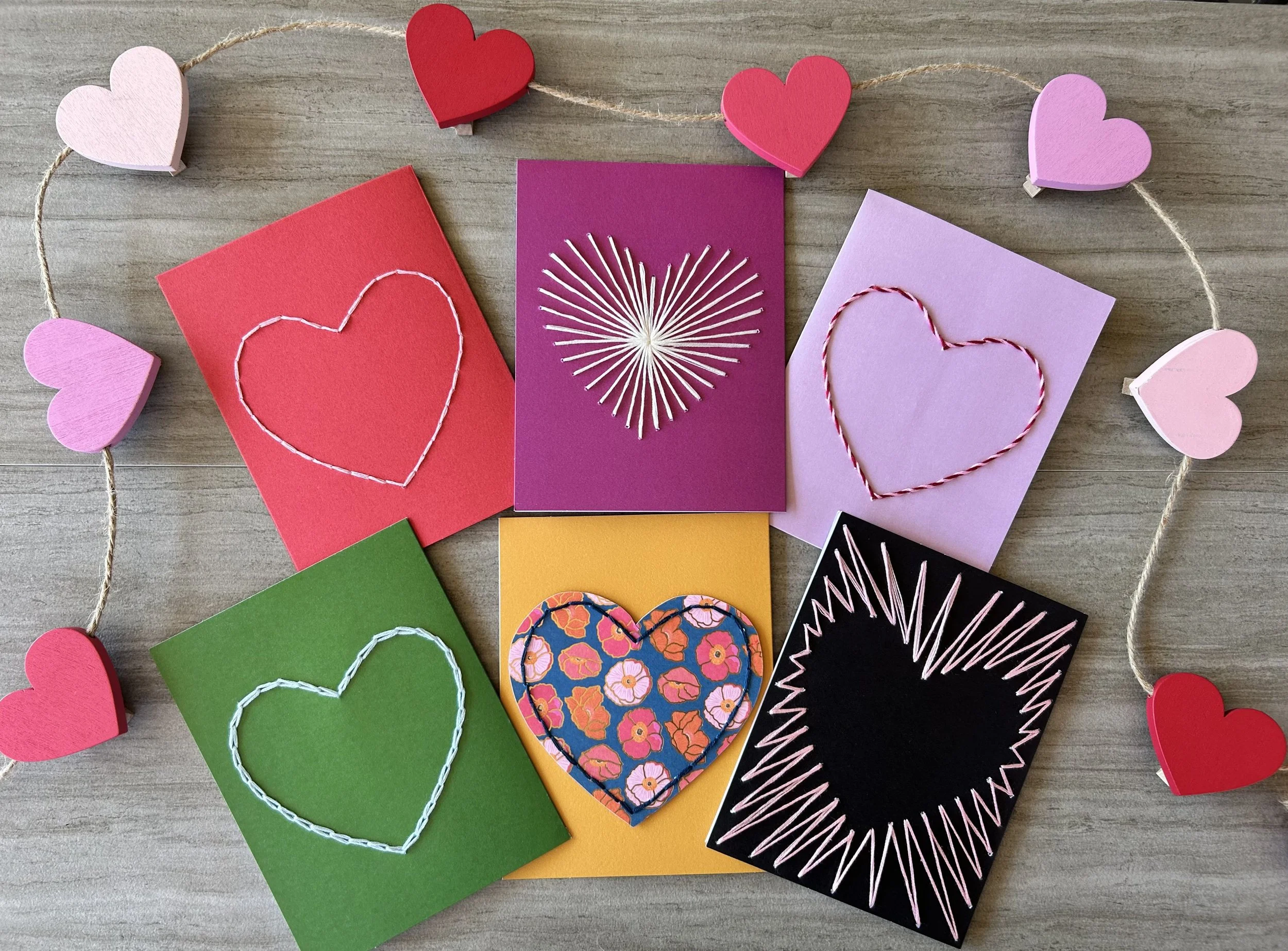Rotating photos of embroidered heart cars, woven circle mandala on embroidery hoop, watercolor wood frame with embroidered quote, wood block pixelated flowers, ice cream pinata making station, glass tiled mosaic wood frames, pear/watermelon/avocado/c