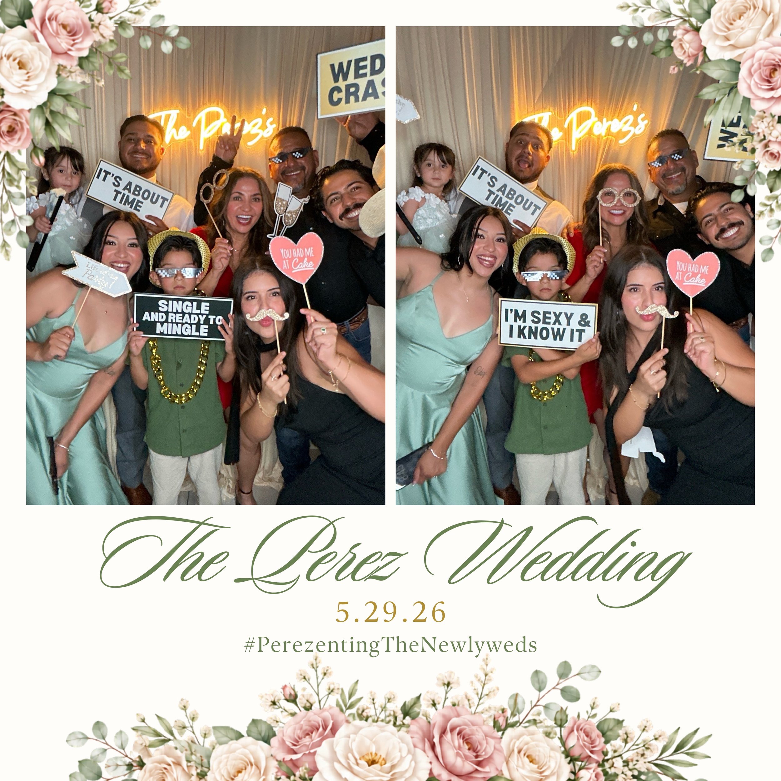 A close-up of a group of people at a wedding celebration, holding signs with humorous messages, surrounded by floral decorations and a neon sign that reads 'The Perez' in the background.