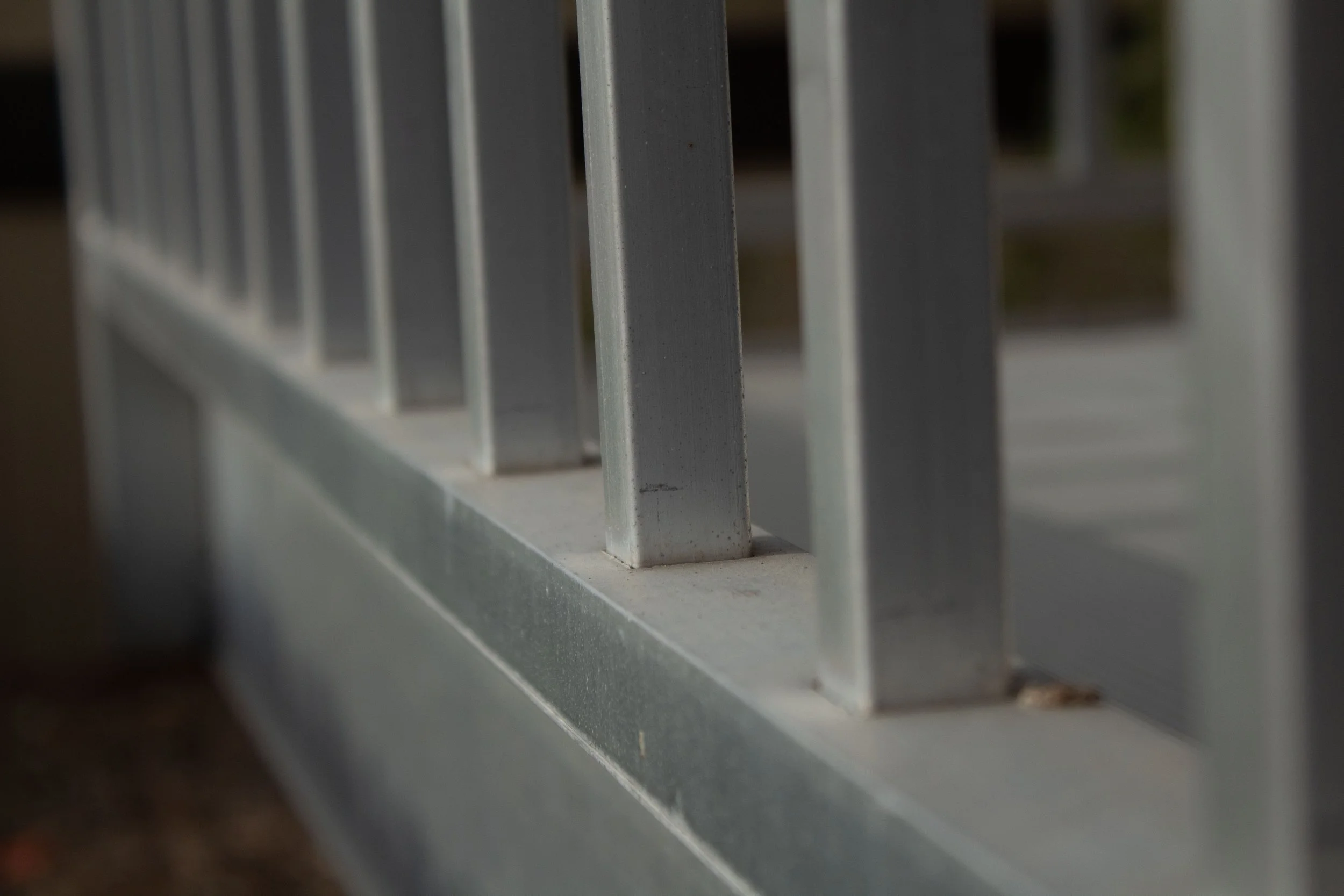 Close-up of a metal railing on a balcony or fence.