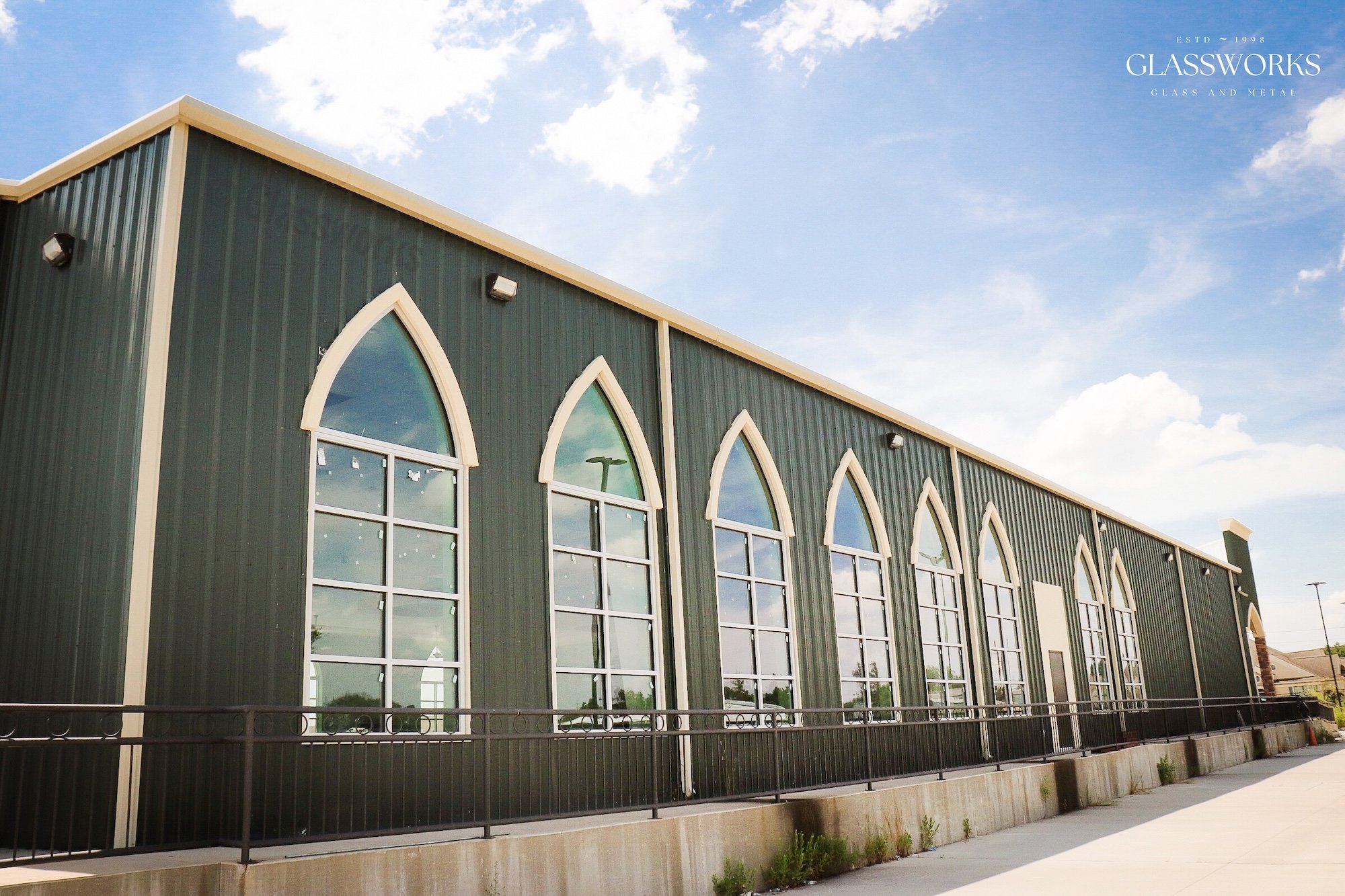 Commercial glass installation on modern metal building with tall arched windows by Glassworks in Houston TX
