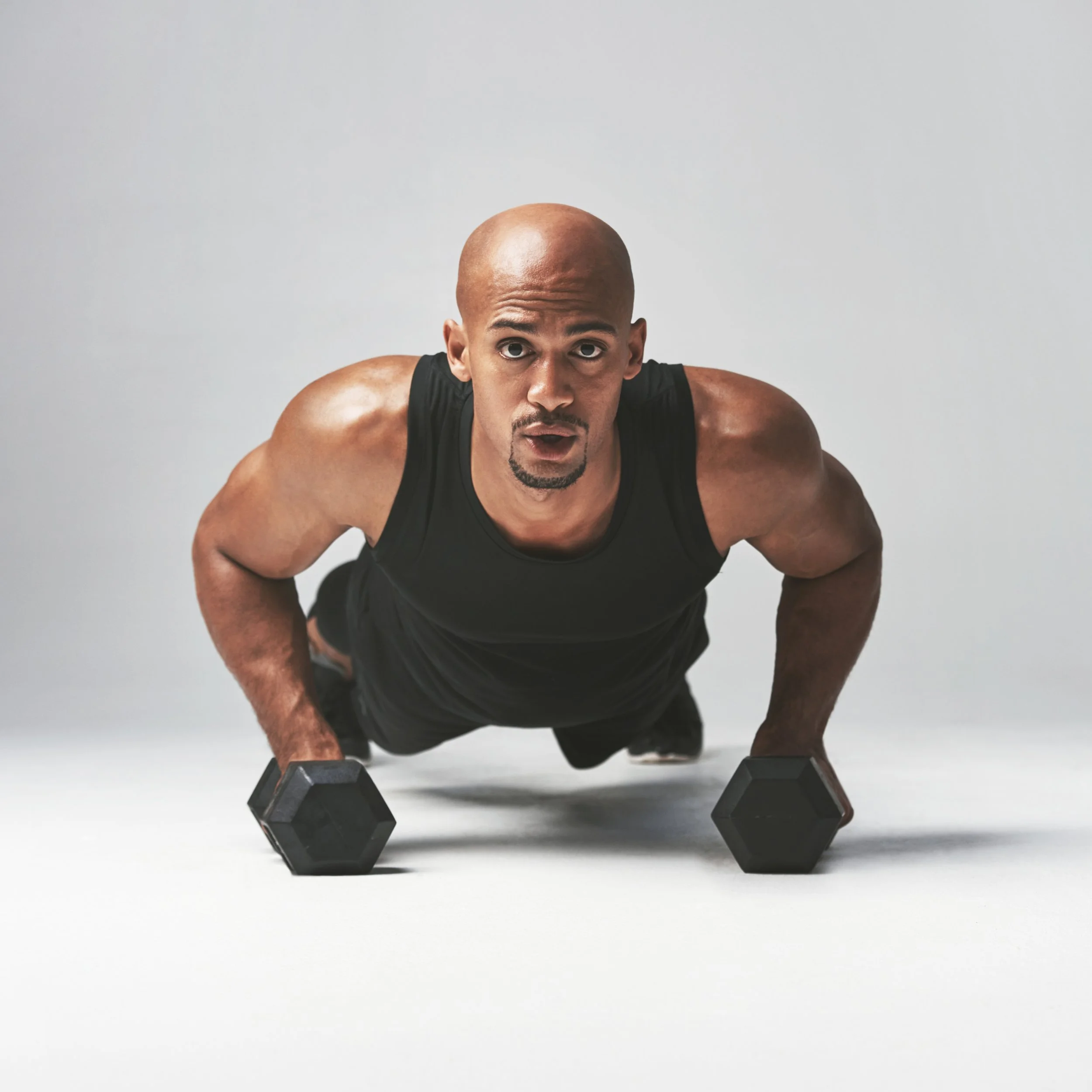 muscular-man-doing-push-ups-with-dumbbells-2026-01-09-10-03-17-utc.jpg