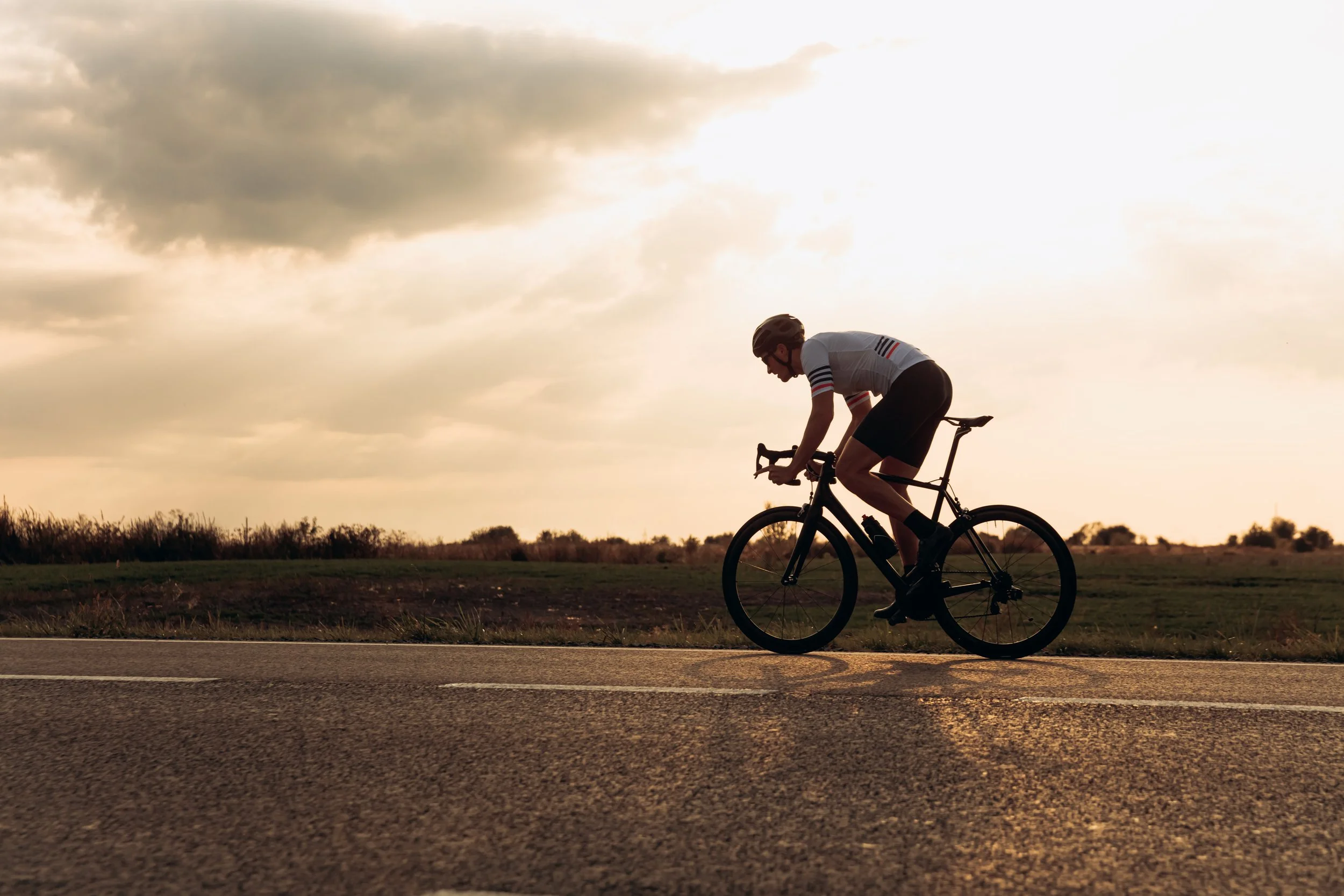 cyclist-races-down-paved-road-at-sunset-2026-03-17-14-46-32-utc.jpg