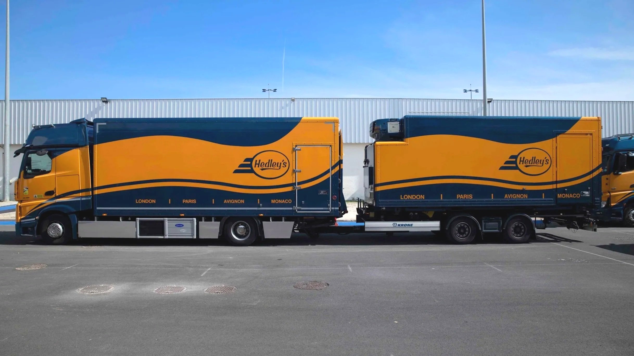 A large truck with Hedley's branding parked in a parking lot.