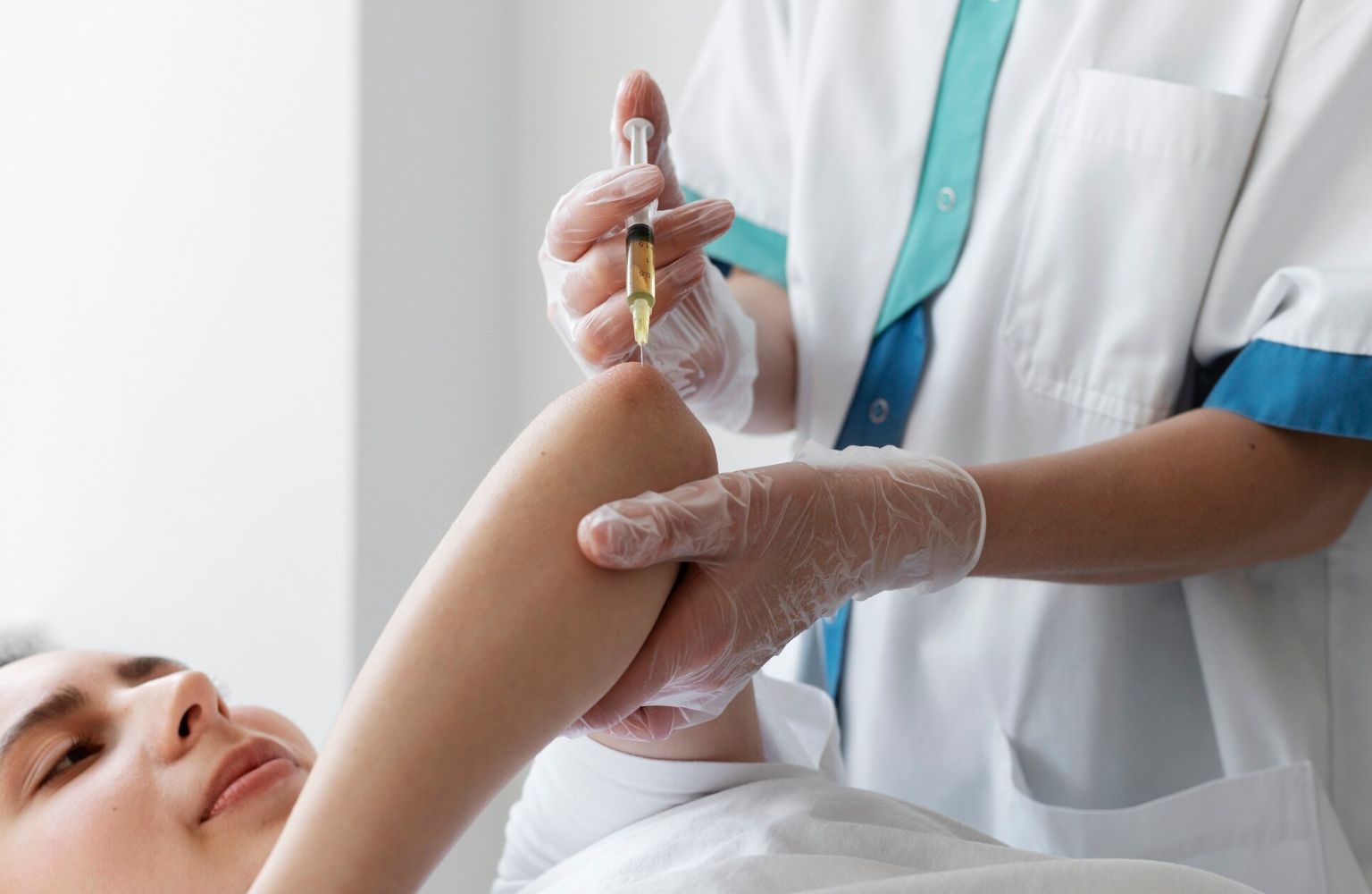 A healthcare professional administering an injection to a patient in a medical setting.