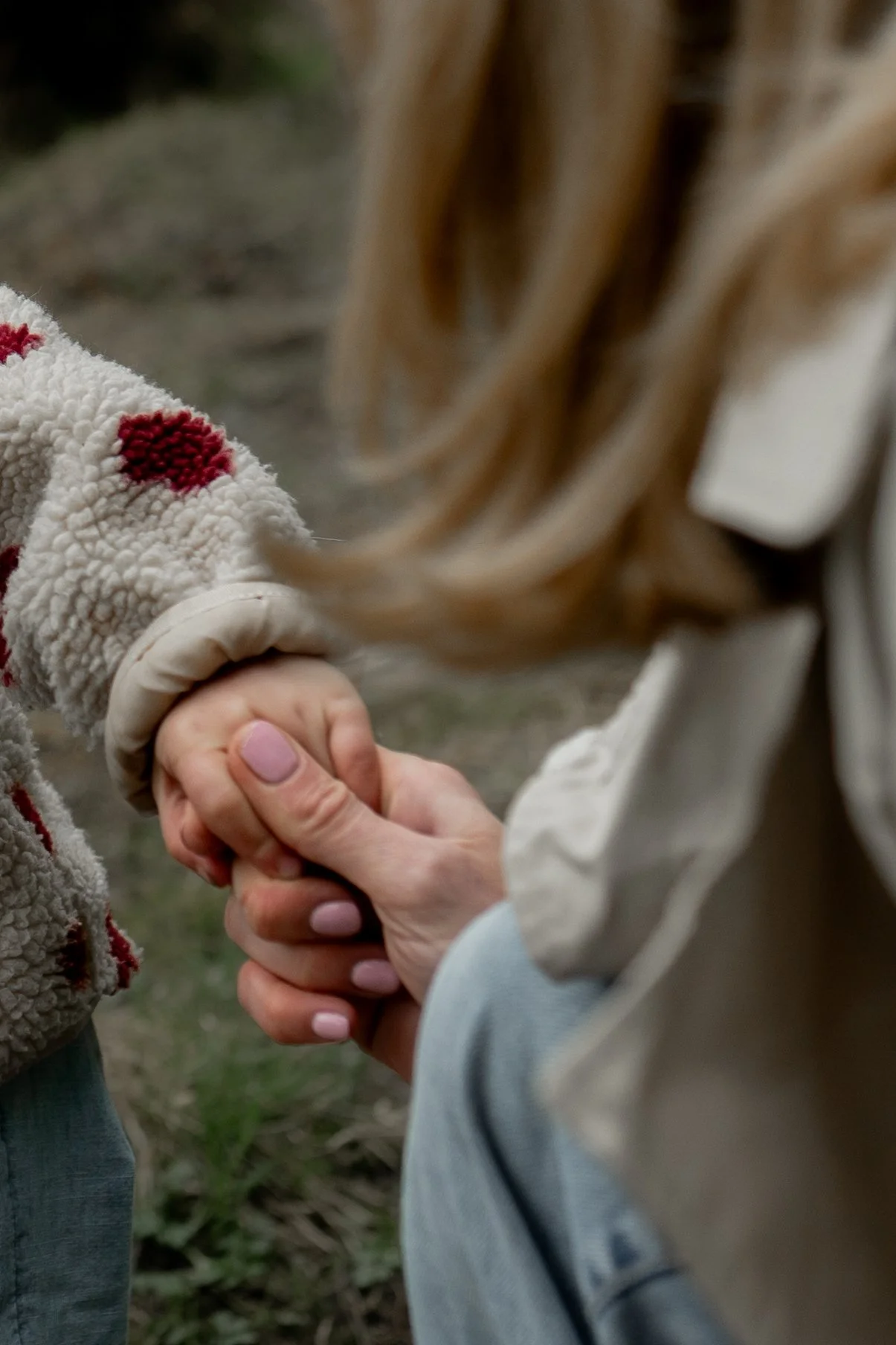 mum and daughter holding hands, natural candid family photography at loch ard Scottish highlands