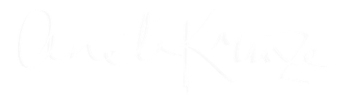 Signature of the name 'Anete Krūze' in white cursive on a black background.