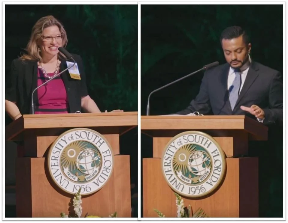 Two people standing at podiums with University of South Florida logos, one woman on the left speaking and a man on the right listening.