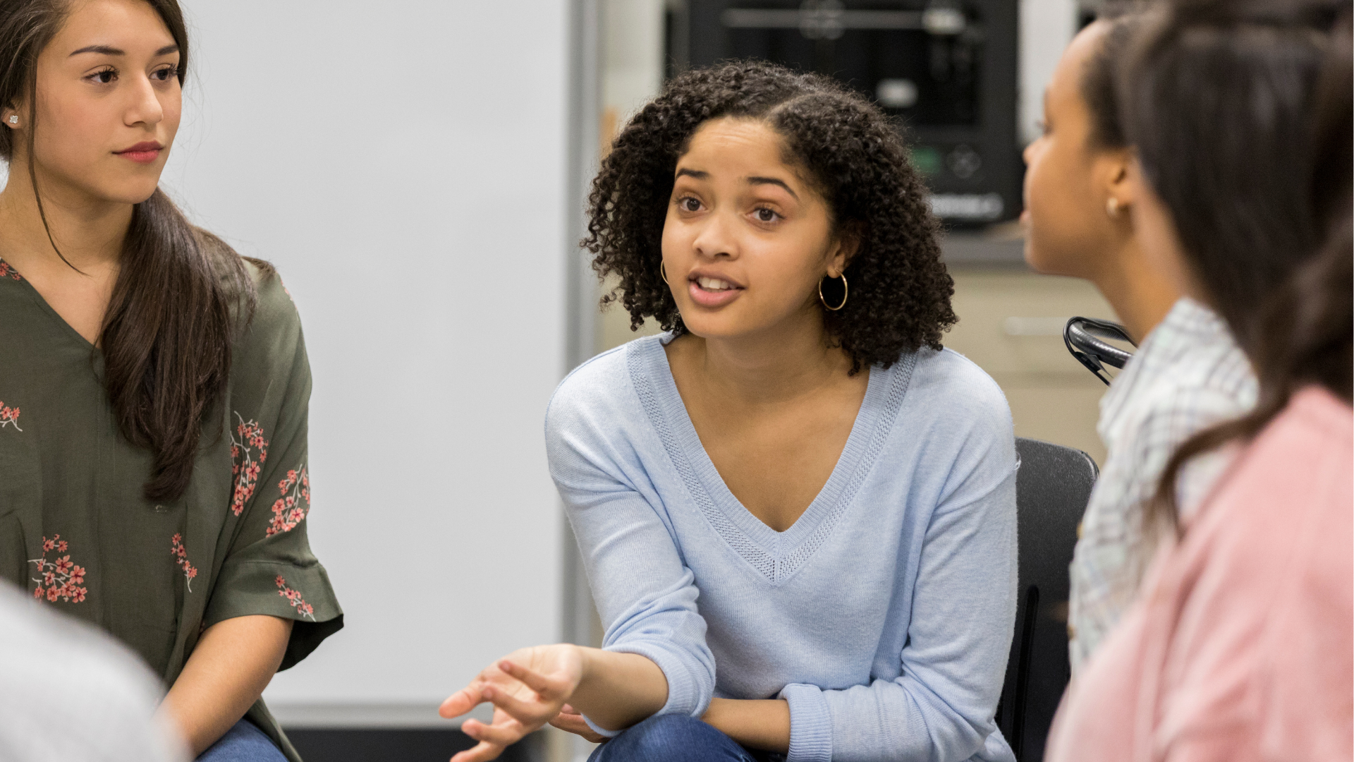 Group of diverse women having a discussion in an office