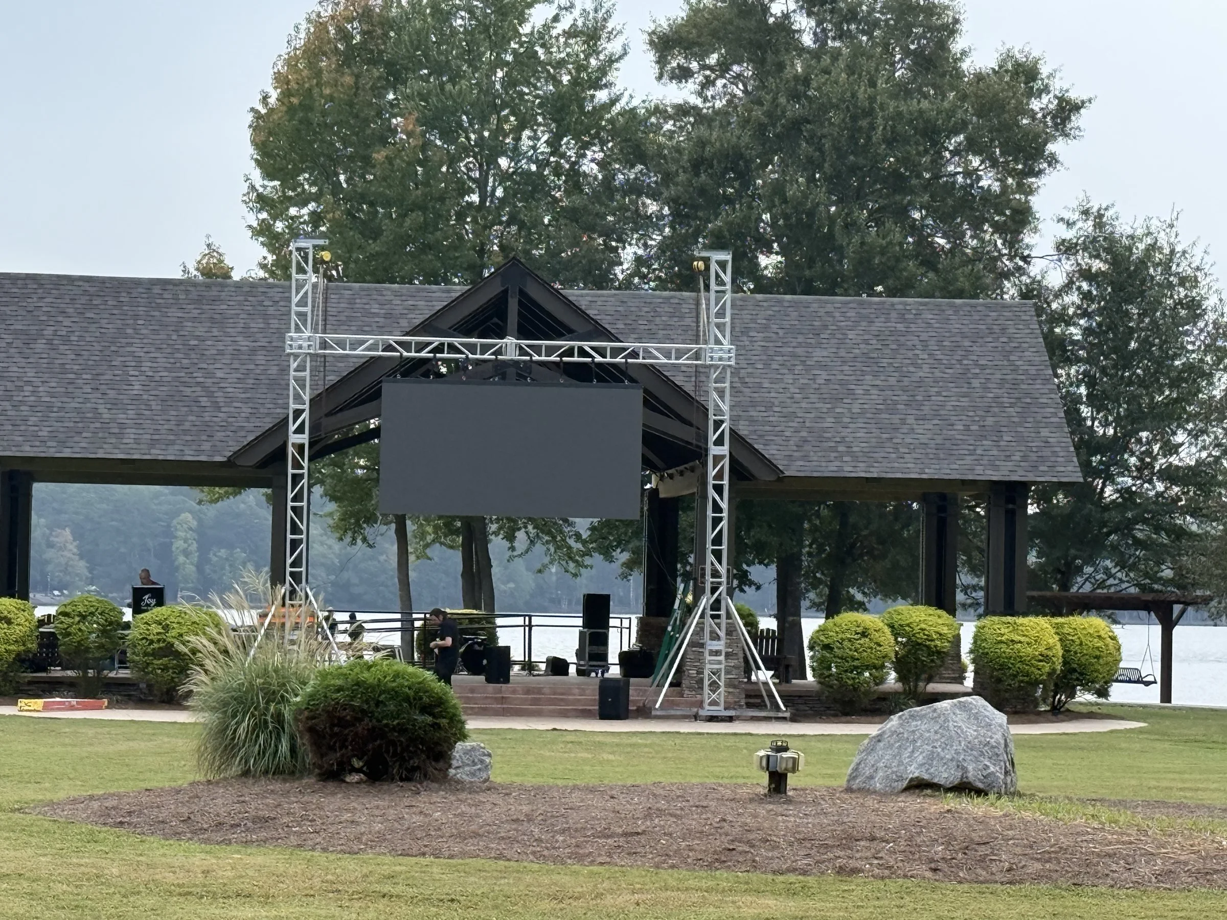 Outdoor concert stage with truss towers and PA at Drake Field Pavilion, Peachtree City